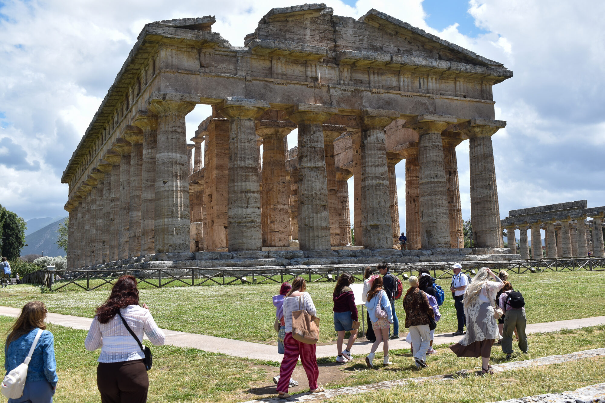 Group walking to ancient temple in Italy